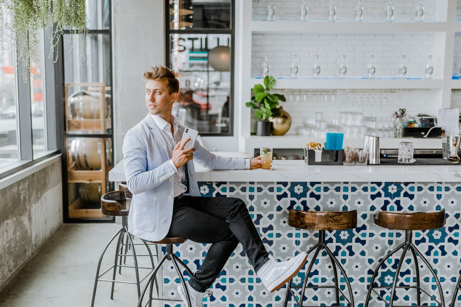 A man sitting alone in a coffee shop waiting for a client that will never appear.